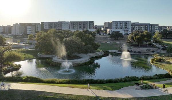 The Grove park and residential and office buildings in the background