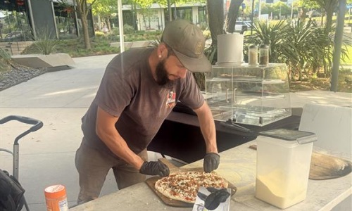 a man making pizzas