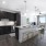Spacious and well lit kitchen with wood flooring and stainless steel appliances