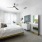 Large well lit bedroom with plush carpets and large windows 