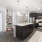 Spacious and well lit kitchen with wood flooring and stainless steel appliances