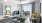 Spacious and well-lit living room with wood flooring and french doors at Korina at The Grove, a new apartment complex in Austin, TX