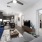 Spacious and well lit living room with wood flooring, large windows and open access to the kitchen