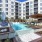 Large sparkling blue pool with a large pool deck and lounge chairs