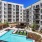 Large sparkling blue pool with a large pool deck and lounge chairs